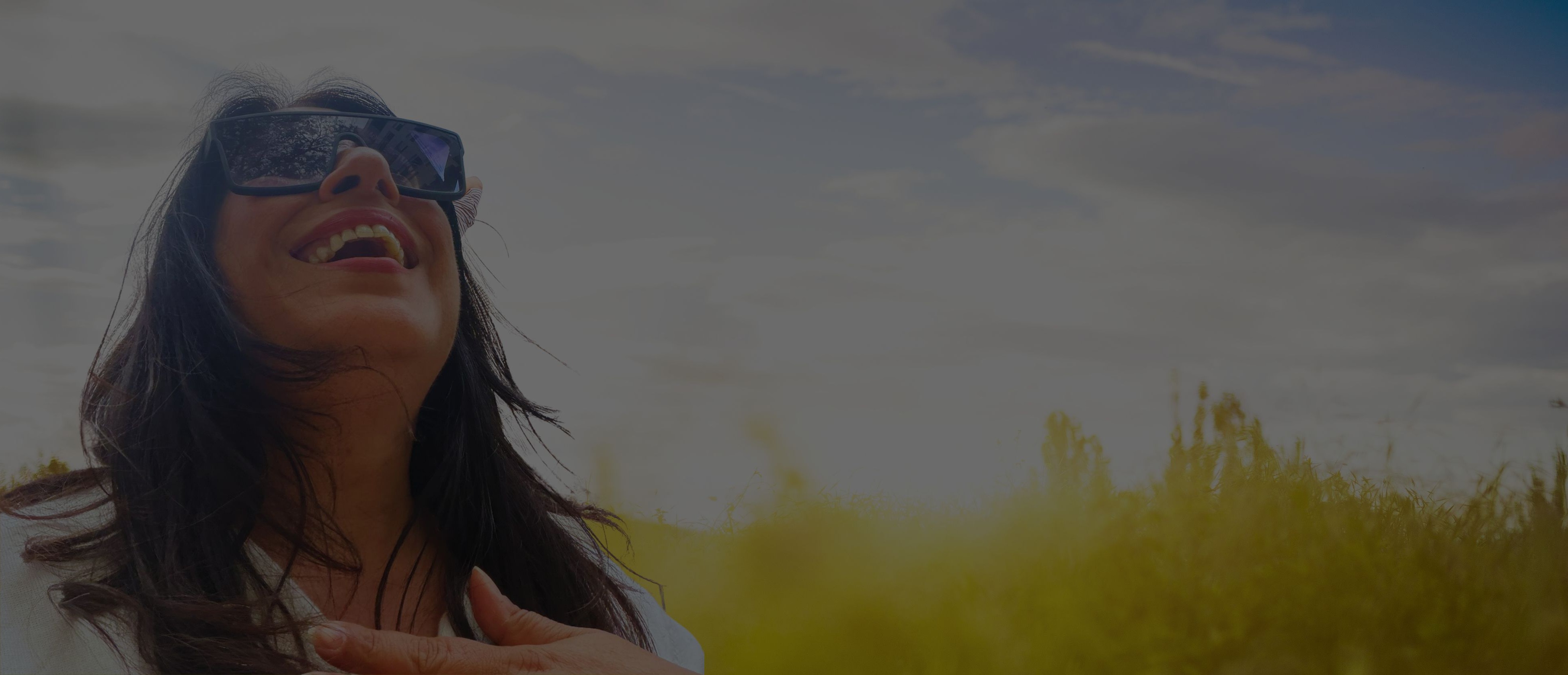 Woman smiling freely in a sunlit field